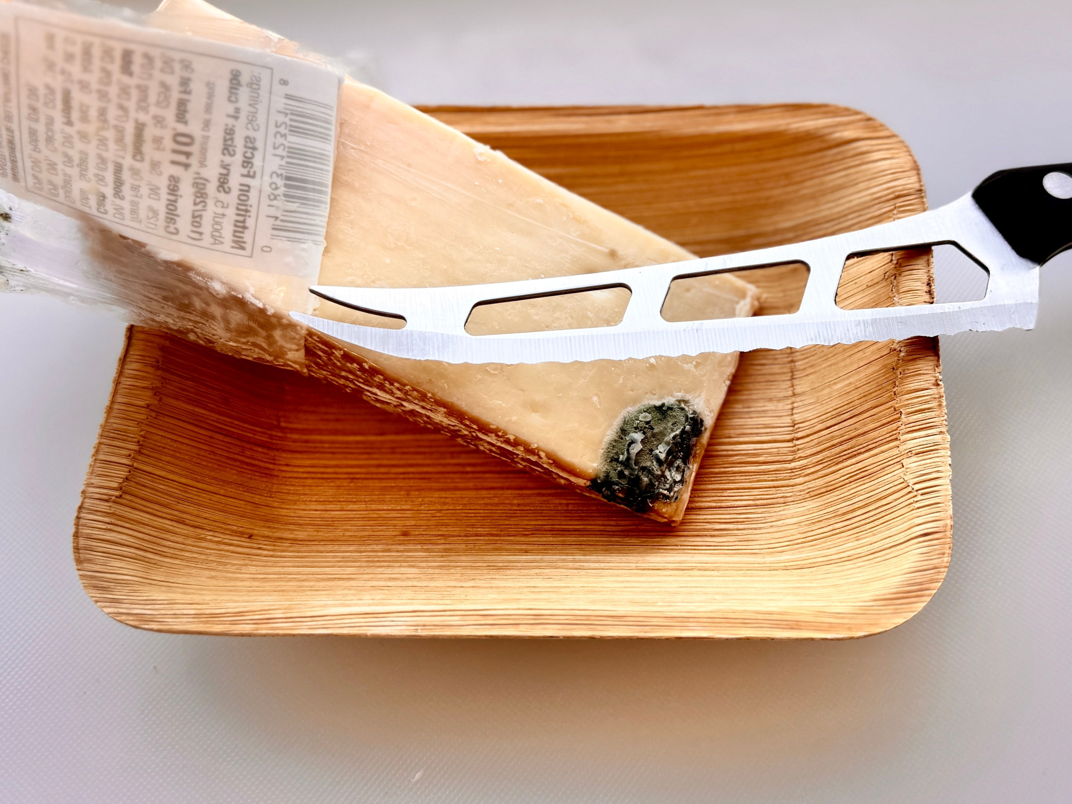 Parmesan Wedge with visible mold and cheese knife